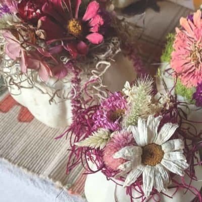 mini pumpkins decorated with dried flowers