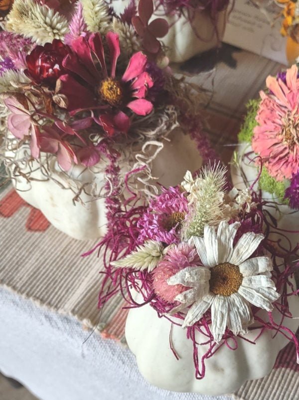 mini pumpkins decorated with dried flowers