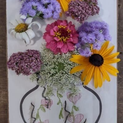 flowers on cardboard with colored vase