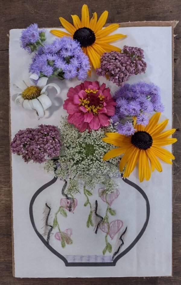 flowers on cardboard with colored vase