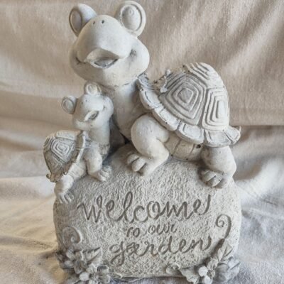 Welcom to our garden words on stone with turtles on top