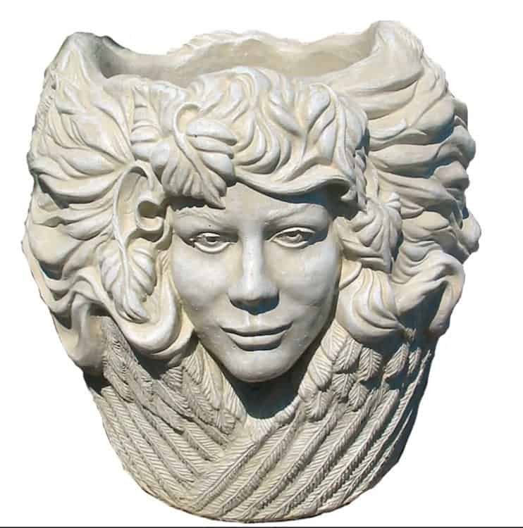 concrete flower pot with 3 faces around it