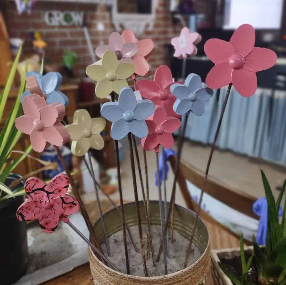 Small concrete flowers on stake