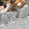 cement ghosts with arms up
