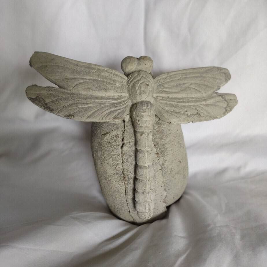 concrete dragonfly on a rock