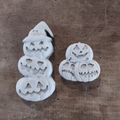 Small concrete trio of pumpkins