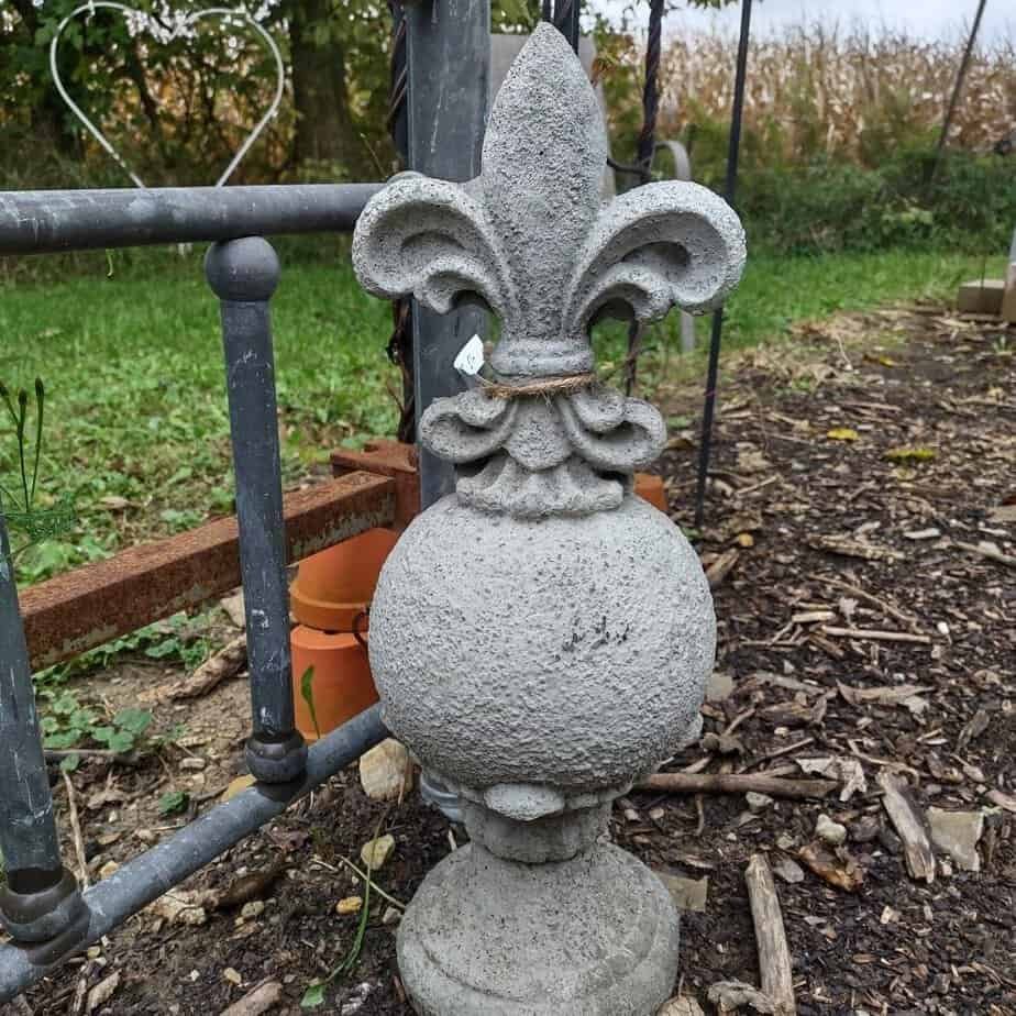 concrete fleur di lis on top a round sphere