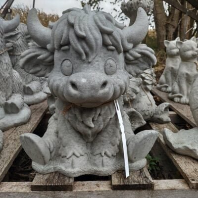 concrete cow with big eyes and long hair