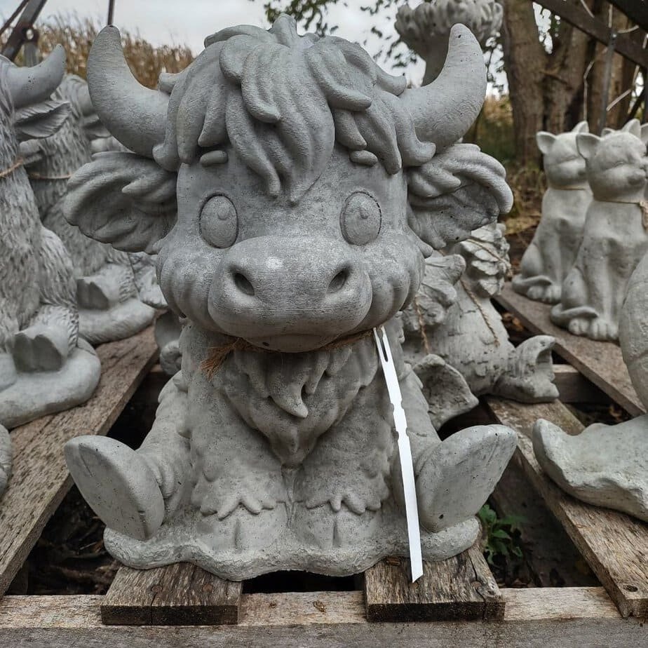 concrete cow with big eyes and long hair