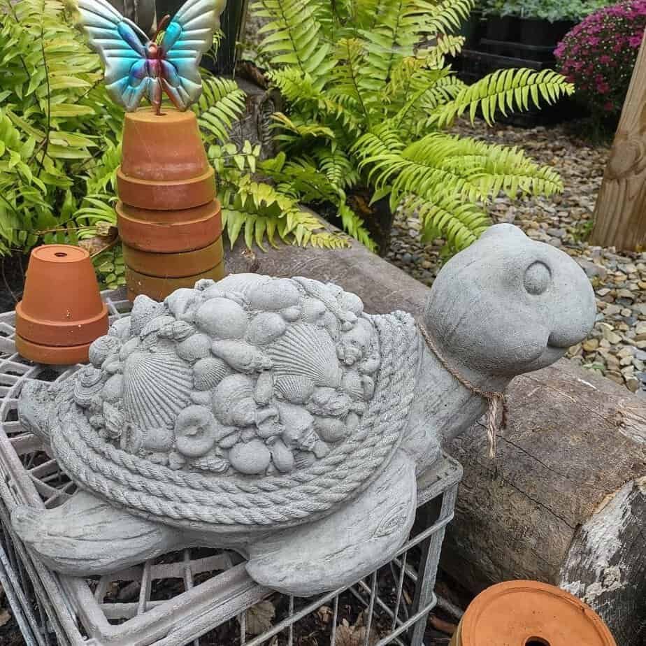 large concrete turtle with shells on it's shell